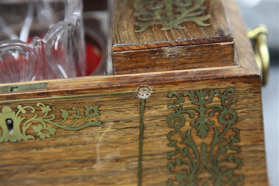 A Regency rosewood and brass inlaid sarcophagus shaped tea caddy, 13.75in.